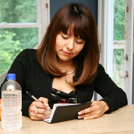 The Basics woman writing check