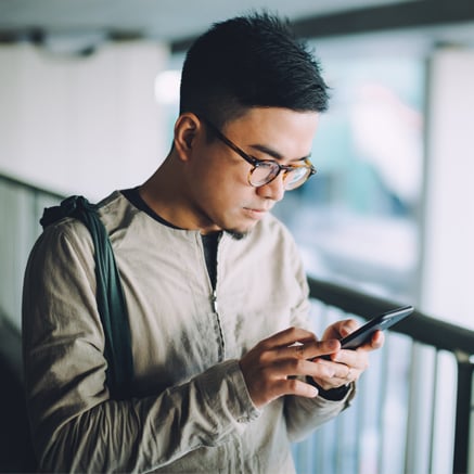 FREE Features man looking at mobile phone