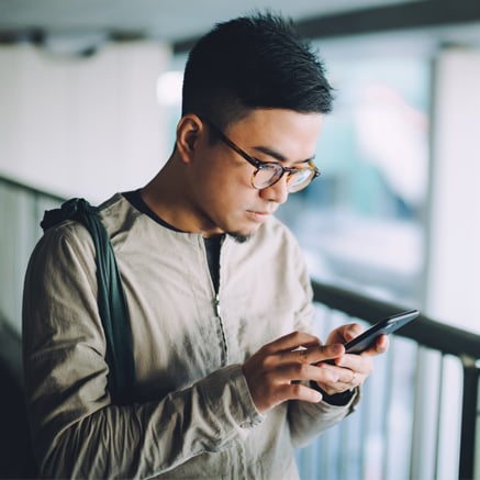 man looking at mobile phone