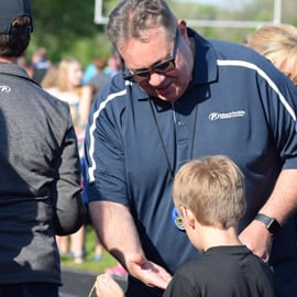 Making a Difference PREMIER Employee giving high five to child