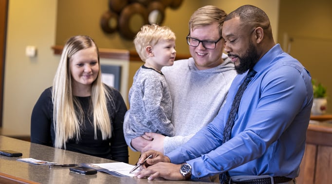 mortgage banker having discussion with young family