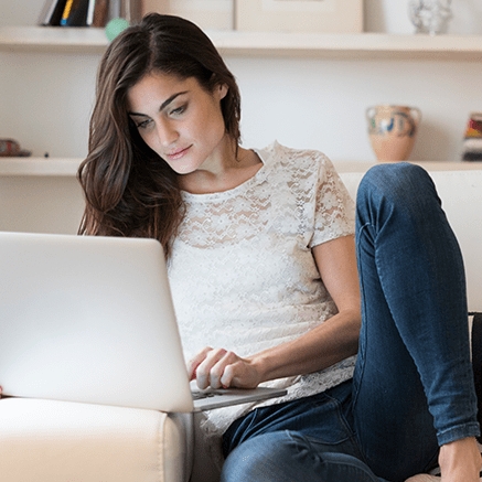 Full Control Features woman on couch using laptop