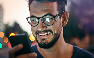 man looking at mobile phone smiling