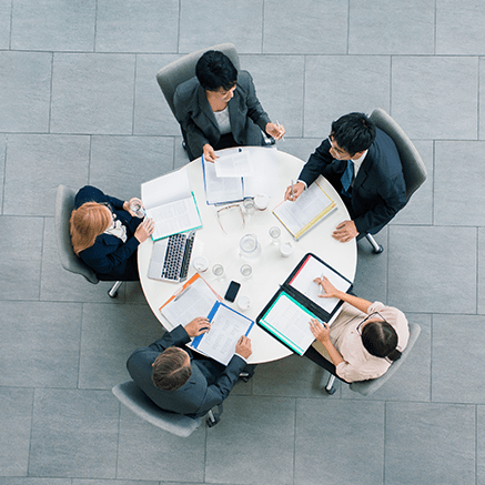 people sitting around conference table