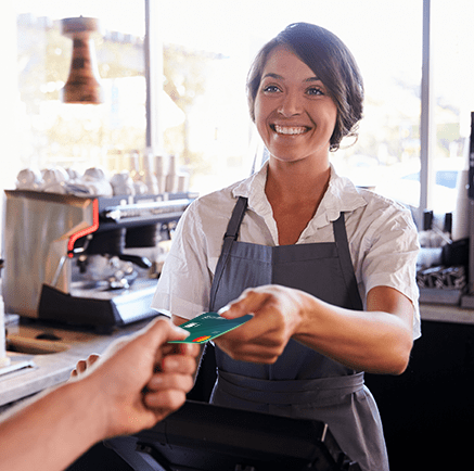 woman cashier accepting credit card for payment