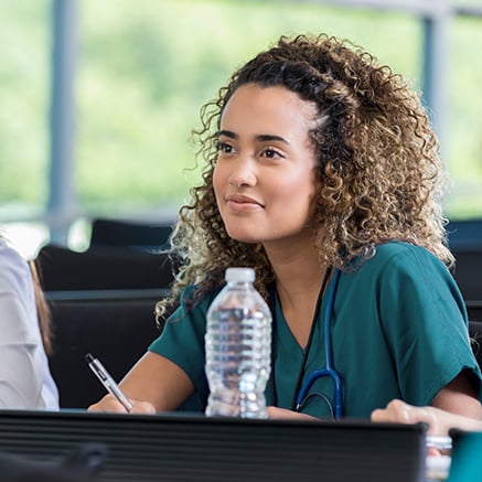 students in scrubs with stethoscope