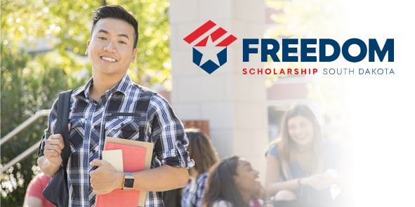 Young man with text books - text saying Freedom Scholarship South Dakota