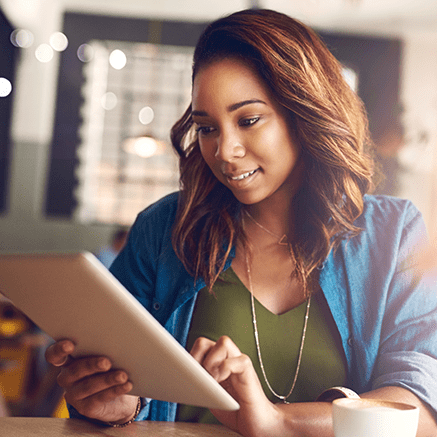 woman looking at features of CD's on laptop