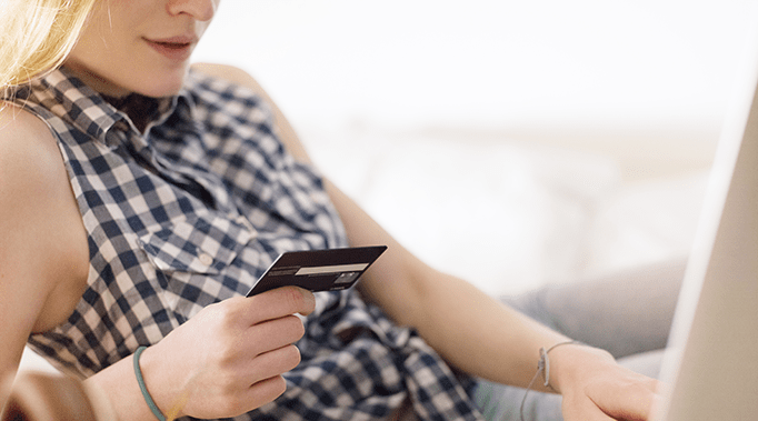 woman looking at credit card