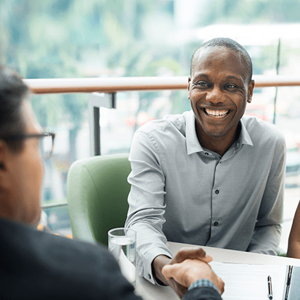 man shaking hands with banker